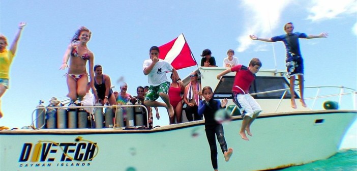 Kids celebrate after a dive during Kids Sea Camp with Divetech in Grand Cayman.