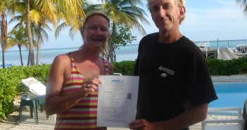 Paula Brazier receiving her certification from Mike Schouten at the Southern Cross Club on Little Cayman.
