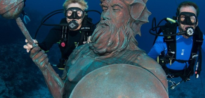 Nancy and Jay Easterbrook welcome the Guardian of the Reef to his new home at Northwest Point. One dollar from every dive on the site will go toward ocean conservation education. Photo courtesy Divetech