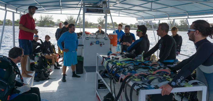 Volunteers aboard a donated Red Sail Sports dive boat listening to a project briefing before entering the water. Photo courtesy Cayman Magic Reef Restoration Project