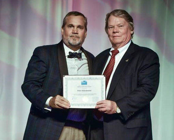 Peter Hillenbrand receiving his Lifetime Achievement Award from the Honourable Moses Kirkconnell Cayman Islands Minister for Tourism. Photo courtesy Cayman Islands Tourism Association.