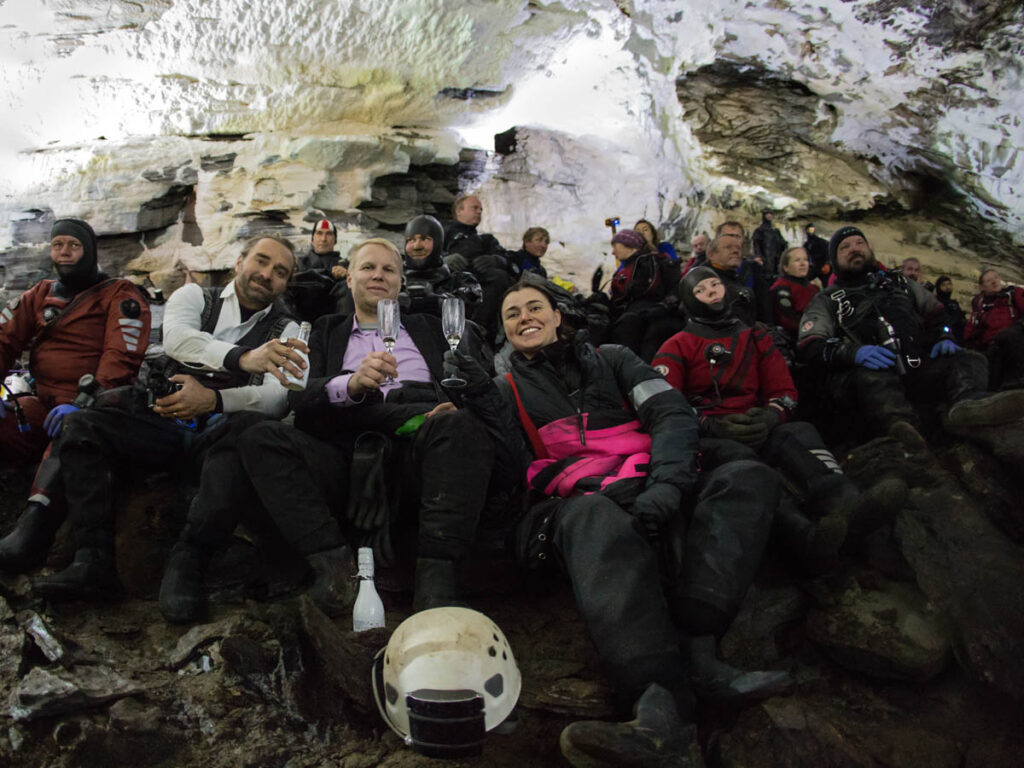 Some of the audience dressed up in proper suits under the dry suit, at the Plura Cave Wedding in 2019. Photo Pekka Tuuri