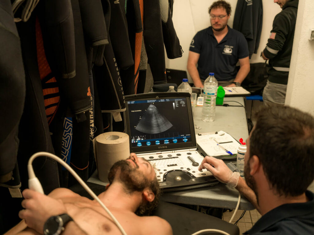 A diver undergoes a cardiac ultrasound examination as part of research into decompression stress following technical diving. Image supplied by Dr Emmanuel Gouin and the research team.