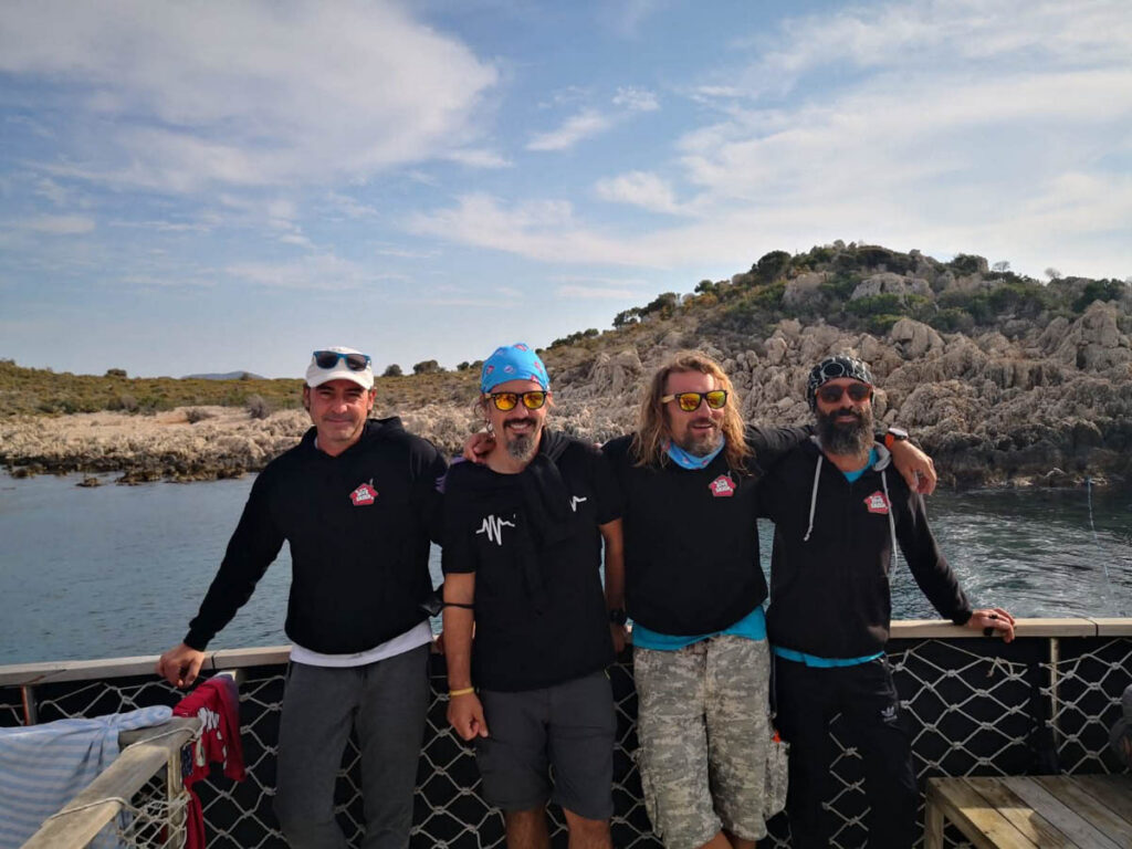 Four members of the Diveshack dive team standing together on a boat near the Karpaz Peninsula